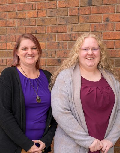 Your Accountant LLC business owners Christa Wilson and Cheree Turner happily posing outside their Lakewood office